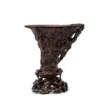 A Chinese wood carved libation cup and stand