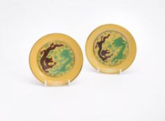 A fine pair of Chinese imperial yellow ground small saucer dishes
