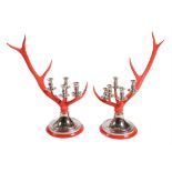A pair of red painted antler and chromed metal mounted five light candelabra by Anthony Redmile