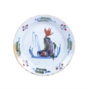 An English delft polychrome plate decorated with a dolphin