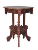 A carved and stained walnut occasional table