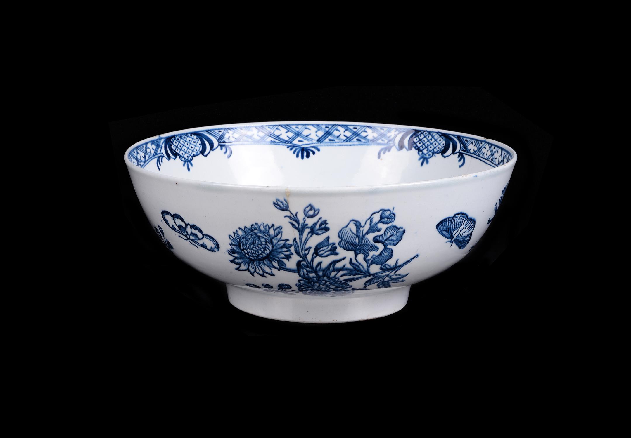 An English porcelain blue and white printed and painted punch bowl