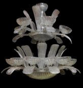 A large moulded clear glass seventeen light chandelier in Art Deco style