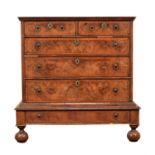 A William & Mary walnut and marquetry banded chest on stand