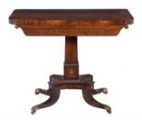 A Regency rosewood and brass inlaid card table