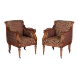 A pair of mahogany and upholstered armchairs in Regency style