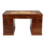 An Edwardian mahogany and leather inset pedestal desk