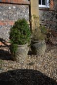 A pair of stone composition garden urns in Arts and Crafts style