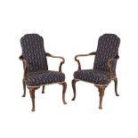 A pair of walnut and upholstered armchairs