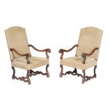 A pair of French oak and upholstered armchairs