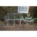 A white painted wrought metal garden seat