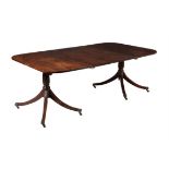 A mahogany twin pillar extending dining table