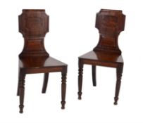 A pair of Regency mahogany hall chairs