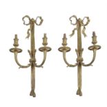 A pair of gilt metal twin light wall appliques in Louis XVI style