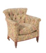 An Edwardian walnut and upholstered tub armchair in the manner of Howard & Sons