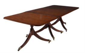 A mahogany and cross banded triple pedestal dining table in George III style