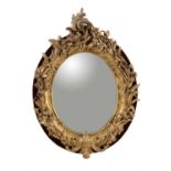 A Victorian giltwood and composition oval wall mirror