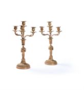 A pair of French gilt metal four light convertible candlesticks in Louis XVI taste