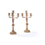 A pair of French gilt metal four light convertible candlesticks in Louis XVI taste