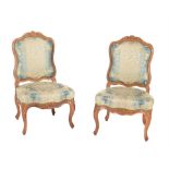 A pair of walnut and upholstered side chairs