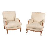 A pair of French carved beech and upholstered armchairs