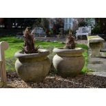 A pair of stone composition garden urns