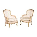 A pair of giltwood upholstered armchairs in Louis XV style