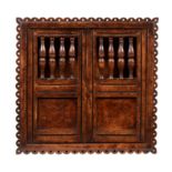 An elm & burr elm mural cupboard in mid 17th century style