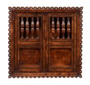 An elm & burr elm mural cupboard in mid 17th century style