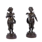 A pair of French patinated bronze models of Cupid and Psyche as infants