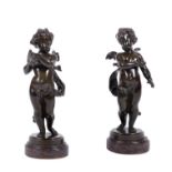 A pair of French patinated bronze models of Cupid and Psyche as infants