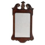 A George II mahogany and parcel gilt wall mirror