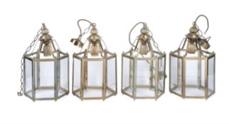 A set of four gilt metal and glazed hexagonal hall lanterns