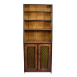 A grained pine and ebonised bookcase side cabinet