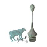 A verdigris copper weathervane modelled as a cow