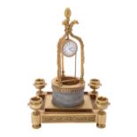 An unusual gilt metal and marble "water well" timepiece