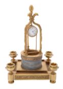 An unusual gilt metal and marble "water well" timepiece