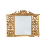 A Continental carved giltwood wall mirror in the German Baroque manner