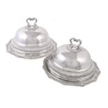 A pair of late George III silver shaped circular vegetable dishes and covers by William Stroud