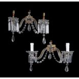 A set of four Victorian cut and moulded glass and gilt metal mounted twin light lustre wall applique