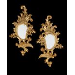 A pair of carved giltwood wall mirrors in the Rococo taste