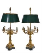 A pair of Restauration gilt metal and verde antico mounted six light candelabra