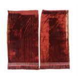 A pair of orange red velvet curtains