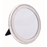 An Edwardian silver small circular dressing table mirror by Mappin & Webb