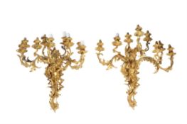 A pair of French gilt metal nine light wall appliques in Louis XV style