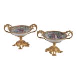 A pair of Cantonese porcelain and gilt metal mounted twin handled tazzas
