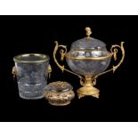 A French engraved clear glass and gilt metal mounted twin-handled pedestal punch bowl and cover