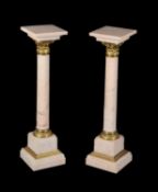 A pair of Continental mottled pink marble and gilt bronze mounted columns