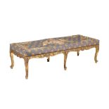 A carved and gilded long stool in the George II style