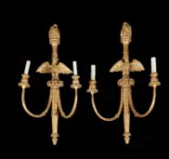 A pair of carved and gilded two branch wall lights in mid-18th century manner
